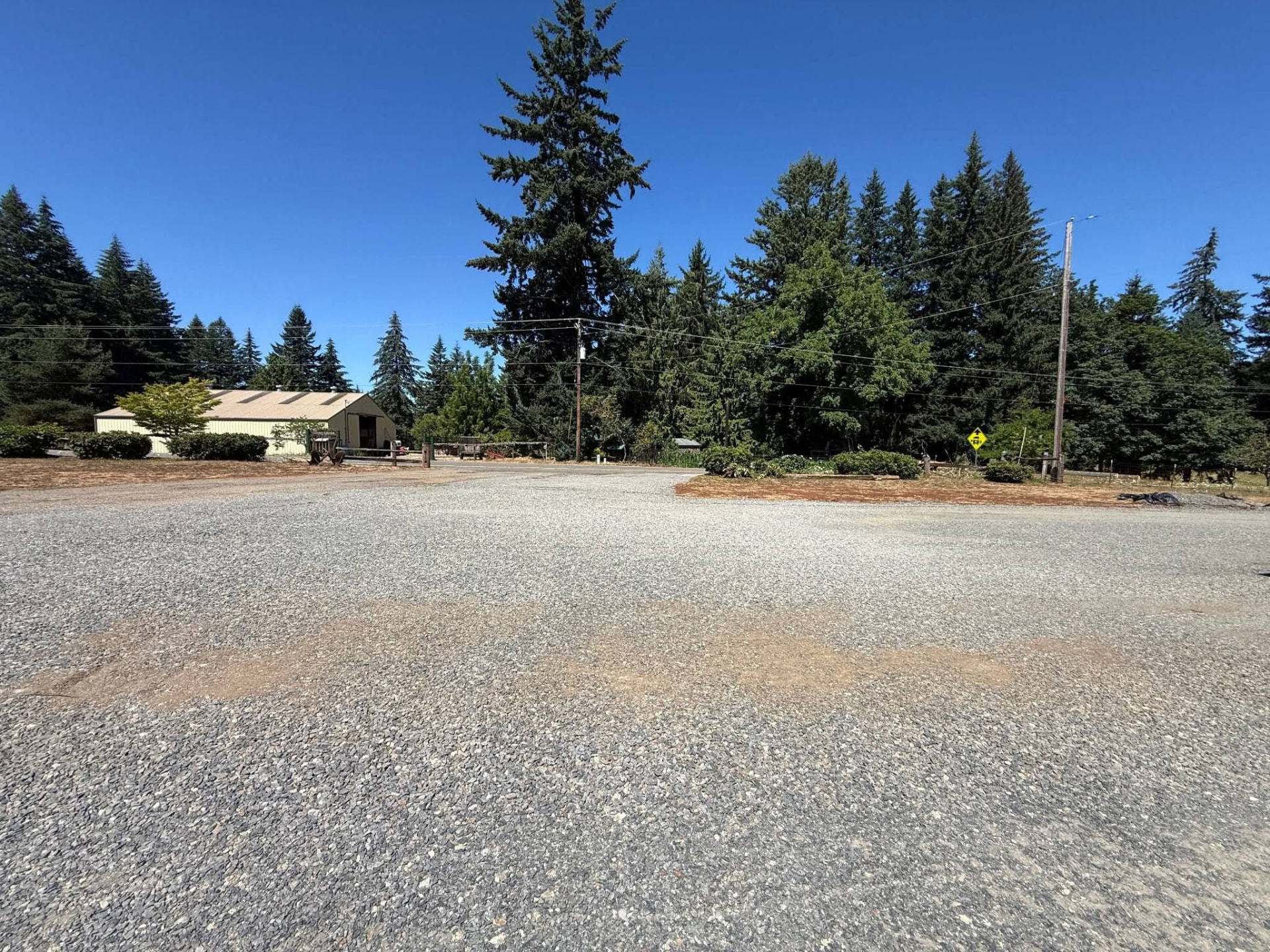 Finished gravel lot in front of a shop building